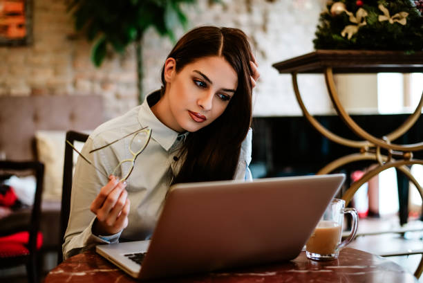 istock Gorgeous long haired woman using laptop at cafe. 912243502