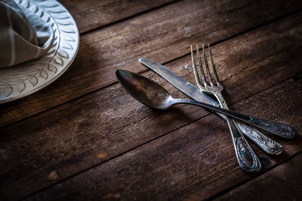 istock Vintage silverware shot on rustic wooden table 912243552