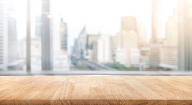 Empty wood table with blur room office and window city view background.For montage product display or design key visual stock photo
