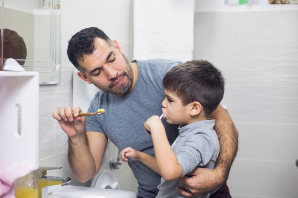 istock Father And Son Brushing Their Theet 912247844