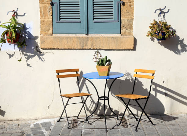 beautiful small iron chairs and a table on sidewalk in Cyprus