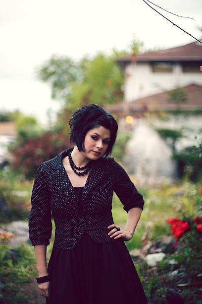 istock Female in Polka Dot Top Standing by a Garden 91225101