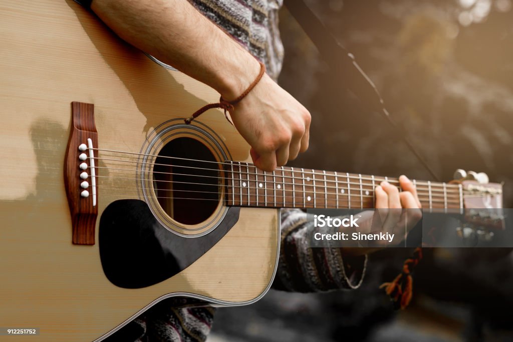 Young musician playing acoustic guitar close up Concert Stock Photo