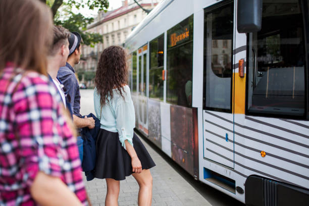 istock Group of young people on a bus/tram stop 912256794