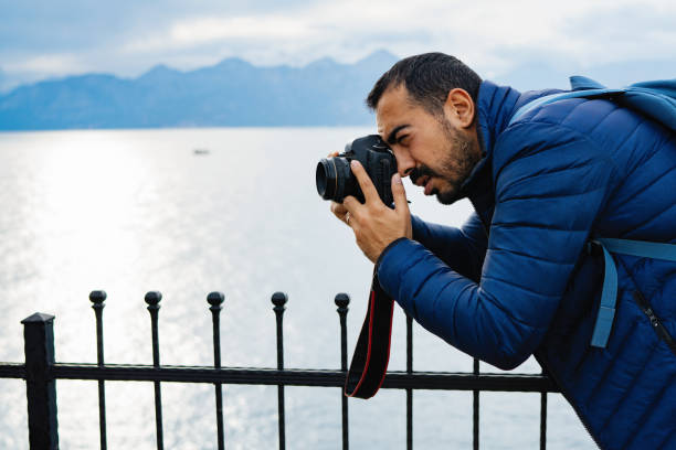 istock Young man photographer shooting on location with backpack 912263422