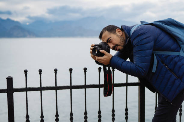 istock Young man photographer shooting on location with backpack 912263570