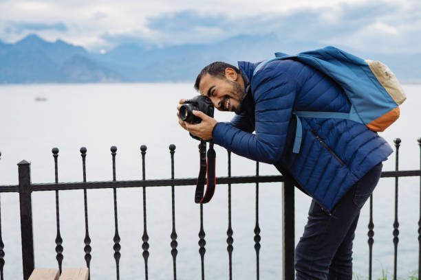 istock Young man photographer shooting on location with backpack 912263678