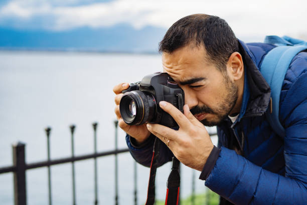 istock Young man photographer shooting on location with backpack 912263744