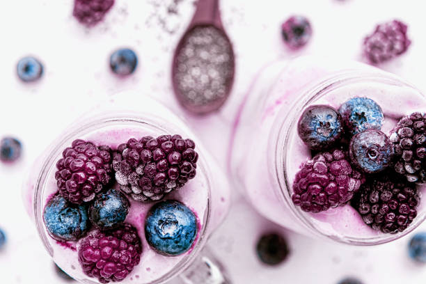 chia with yoghurt, frozen bananas and wild berries, on a white background