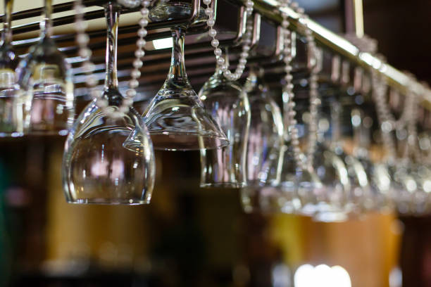 istock Empty glasses for alcohol beverage above a bar rack background 912268194