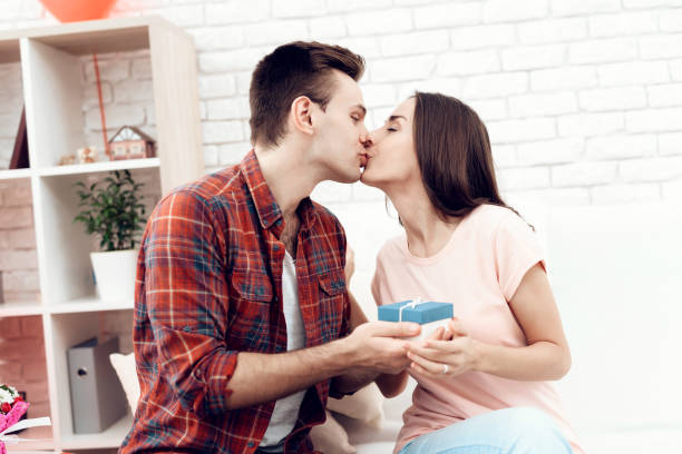istock The guy makes a gift to his girlfriend on Valentine's Day. 912270892