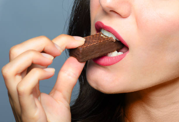 istock Woman eating chocolate cookie 912271002