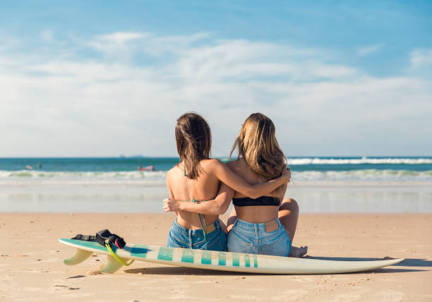 istock Two surfer girls at the beach 912274336