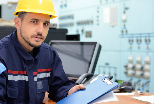istock Young engineer working in electrical room in power substation 912277256