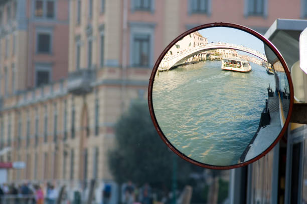 Boat - Vaporetto - going under a bridge on the Grand Canal in Venice-- as viewed through a convex mirror on a vaporetto