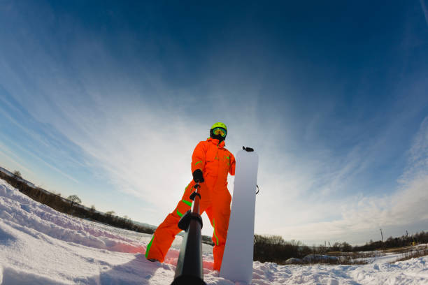 Snowboarder with the snowboard making a selfie stock photo