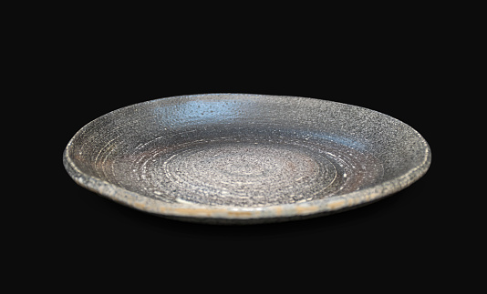 Ceramic flat plate on black background