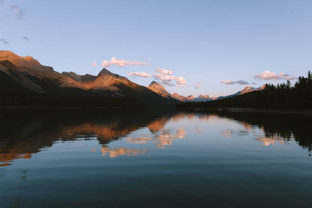 istock Reflections on Maligne lake in Rocky Mountains during colorful sunset with clouds 912281916