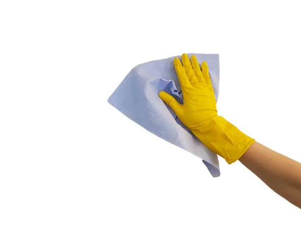 istock female hand in yellow protective rubber glove, blue rag on white background 912290420