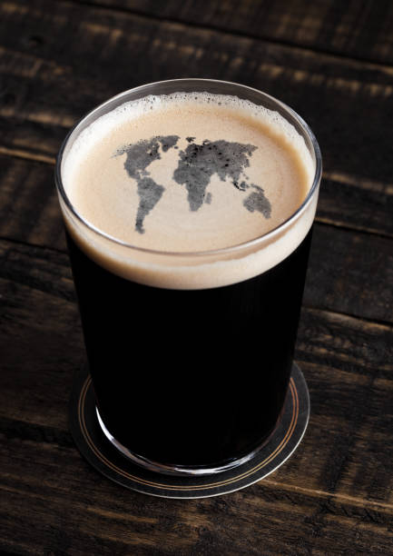 istock Glass of stout beer top with earth shape 912291038
