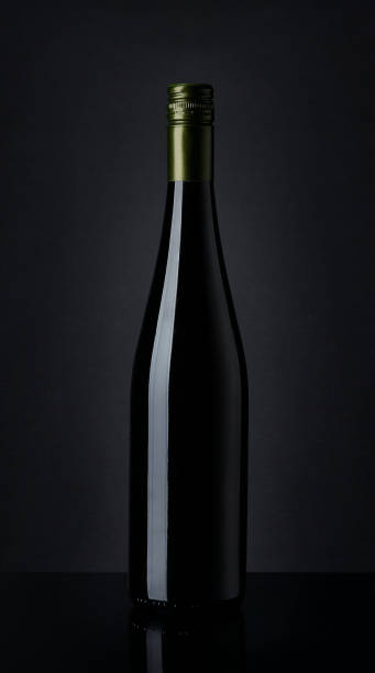 istock Bottle of white wine on black background 912291398