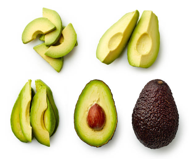 whole and sliced avocado - avocado vegetable ingredient isolated imagens e fotografias de stock