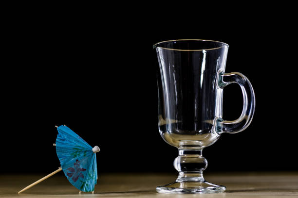 Mai Tai mixed drink with fruit and umbrella garnish on whte background