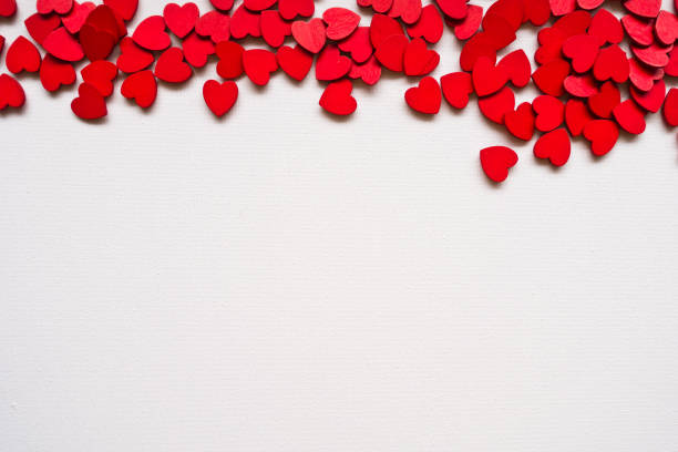 istock Valentines Day background with red hearts on white surface. Romantic seamless pattern for holiday decoration. 912291706