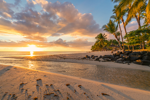 Flic and flac beach at sunset in Mauritius island.