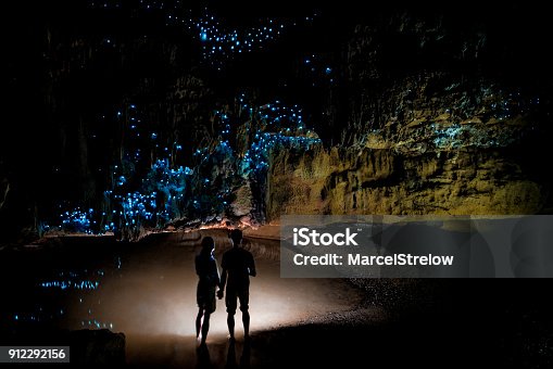 istock Couple standing underneath Glow Worm Sky in Waipu Cave, new Zealand 912292156