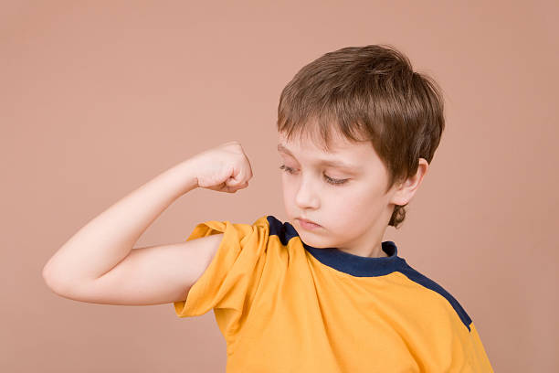 istock Young boy showing off his muscles 91229587