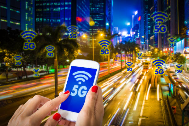 5G or LTE presentation. Woman hand using smartphone with modern city on the background stock photo