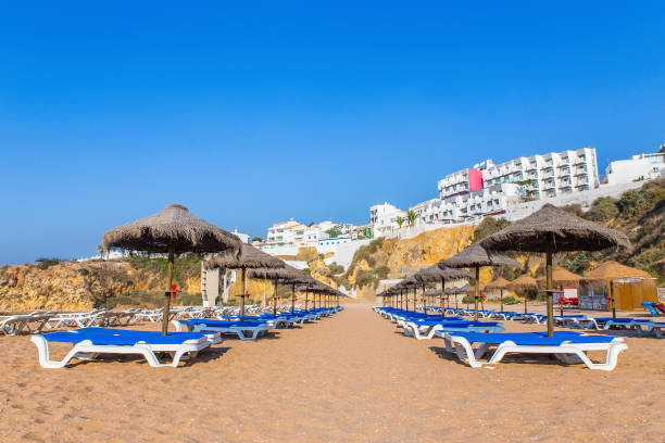 istock Beach parasols with buildings and blue sky 912298702