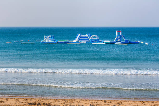Floating playset on blue sea for holiday swimmers. On my vacation in Albufeira in the country Portugal I took this photo. It's a kind of playground for children and other tourists. They can swim in the blue water of the ocean and have fun.