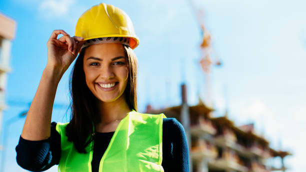 istock Female architect wearing yellow helmet on construction site 912299236