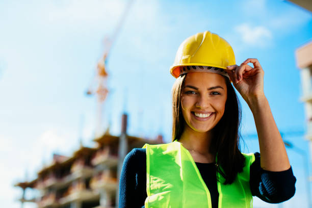istock Beautiful young woman wearing yellow helmet on construction site 912299972