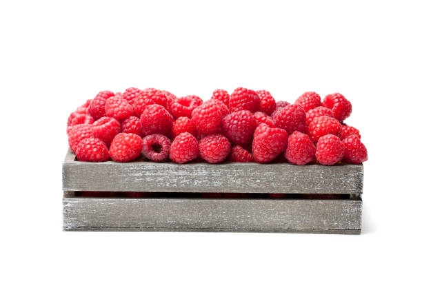 Fresh  selected raspberries on wooden box isolated on white