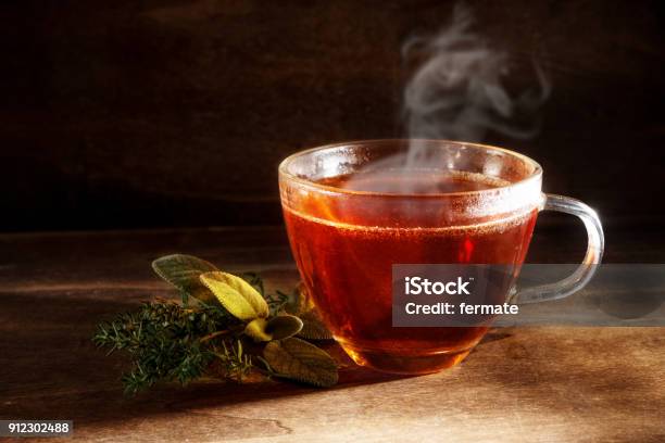 Tea Freshly Brewed In A Glass Cup And Some Herbs On A Dark Rustic Wooden Background Healthy Hot Drink Against Cold And Flu Copy Space Stock Photo - Download Image Now