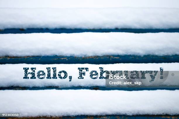 Text Hello February On Old Wood Texture With Snow Stock Photo - Download Image Now - Backgrounds, Beauty, Close-up
