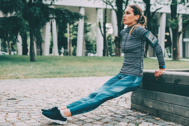 istock Woman doing dips outdoors 912303124