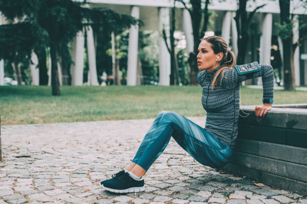 Woman doing dips outdoors Woman doing dips in the city. bicep stock pictures, royalty-free photos & images
