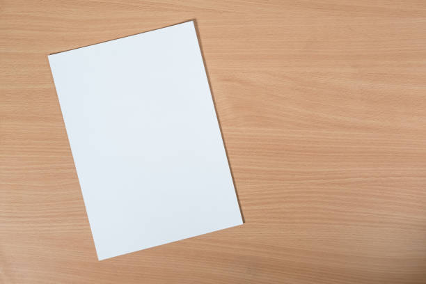 istock blank sheet of paper lying on the table with a place for text 912309794