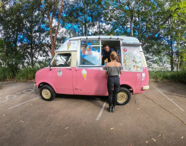 Photo of Young Woman Being Served at an Ice Cream Truck