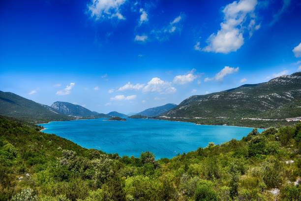istock Landscape over blue water lake between mountains during sunny day 912312658