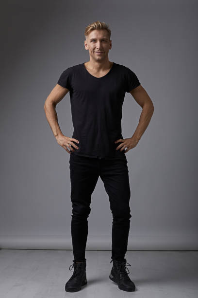 istock Portrait smiling man holding hands on hips 912318448