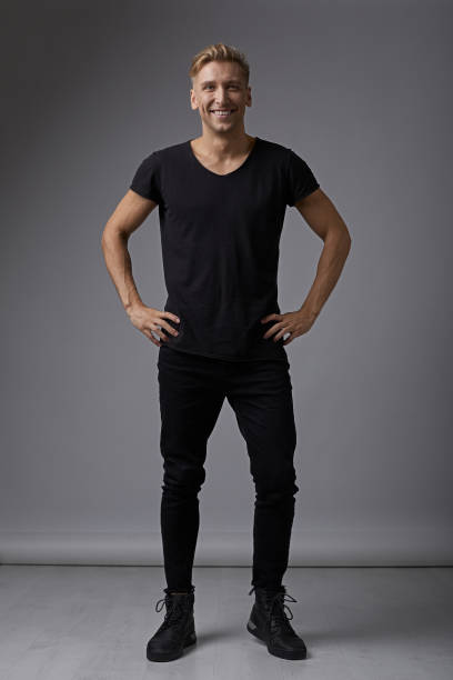 istock Portrait smiling man holding hands on hips 912318454