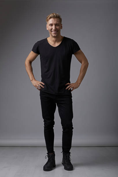 istock Portrait smiling man holding hands on hips 912318464