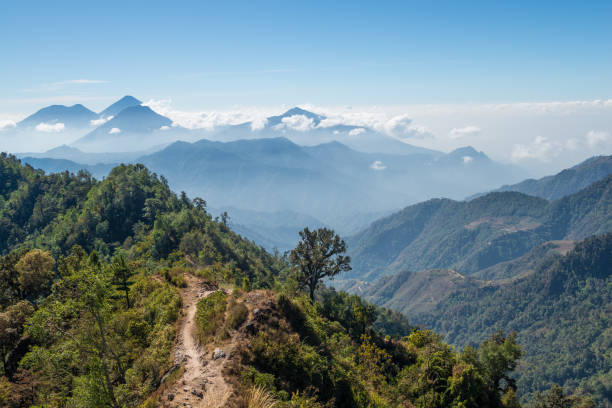 Guatemala highlands vista trail A view of Toliman, Atitlan and San Pedro volcanoes from a hiking trail in the Guatemalan highlands. guatemala landscape stock pictures, royalty-free photos & images