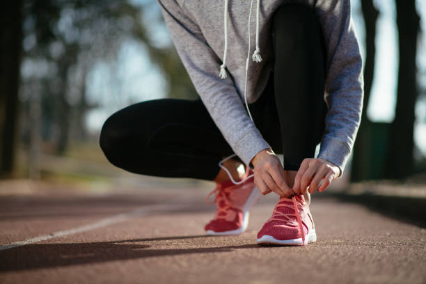 istock Close up of woman preparing for run 912322498