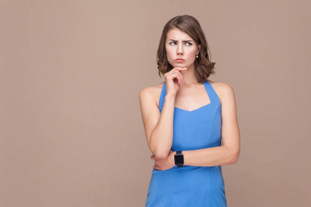 istock Confusion business woman looking up and thinking. 912323360